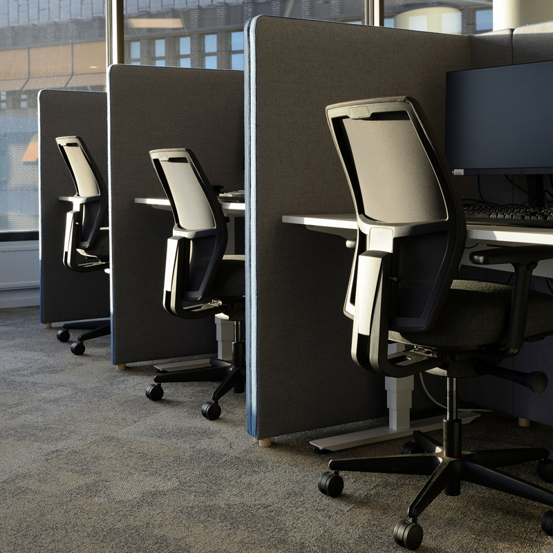 Empty office chairs in a row in office cubicles show strategies to improve office acoustics and reduce office noise for better speech privacy and productivity