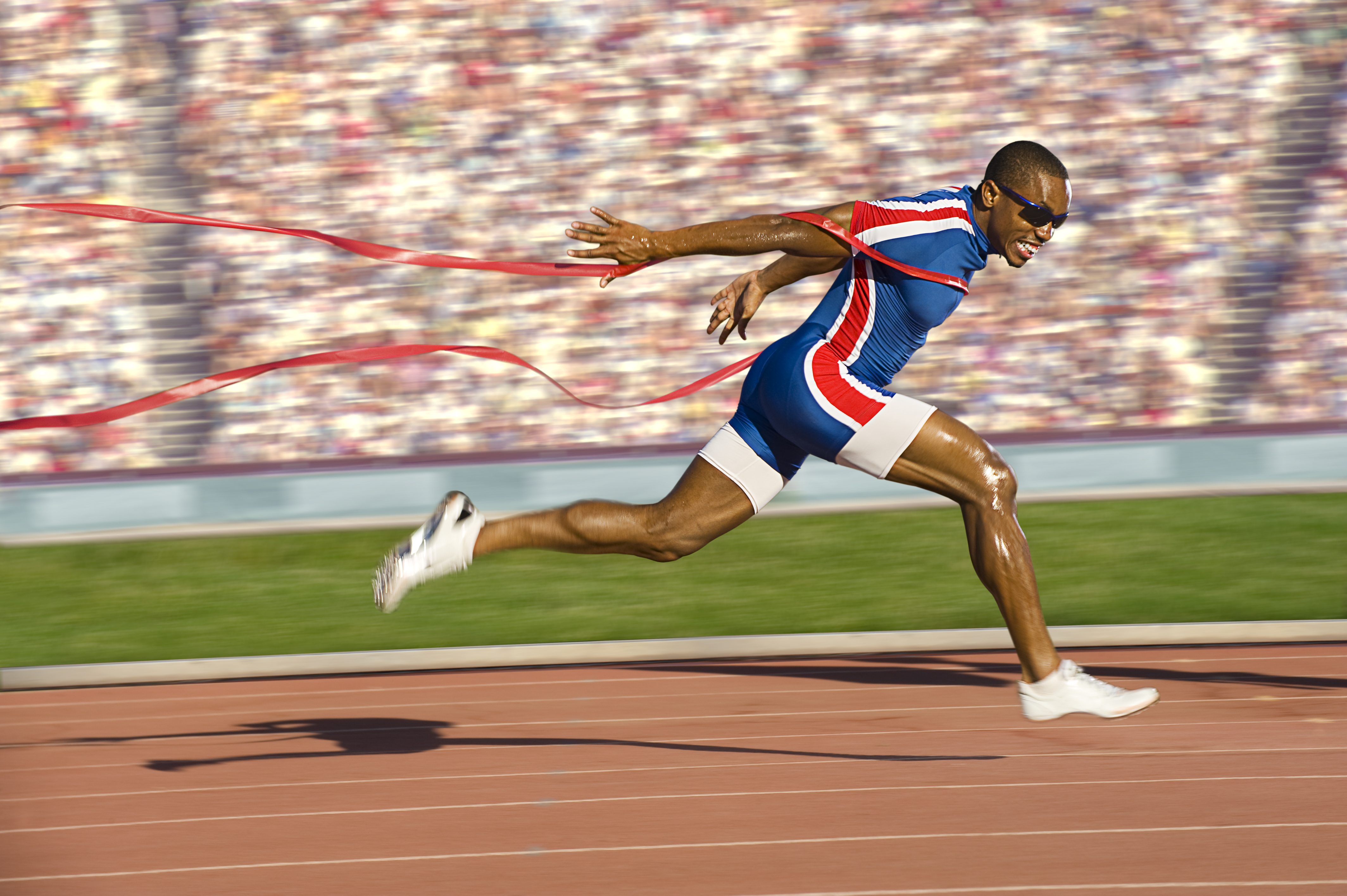 Sprinter running on track in athletics stadium