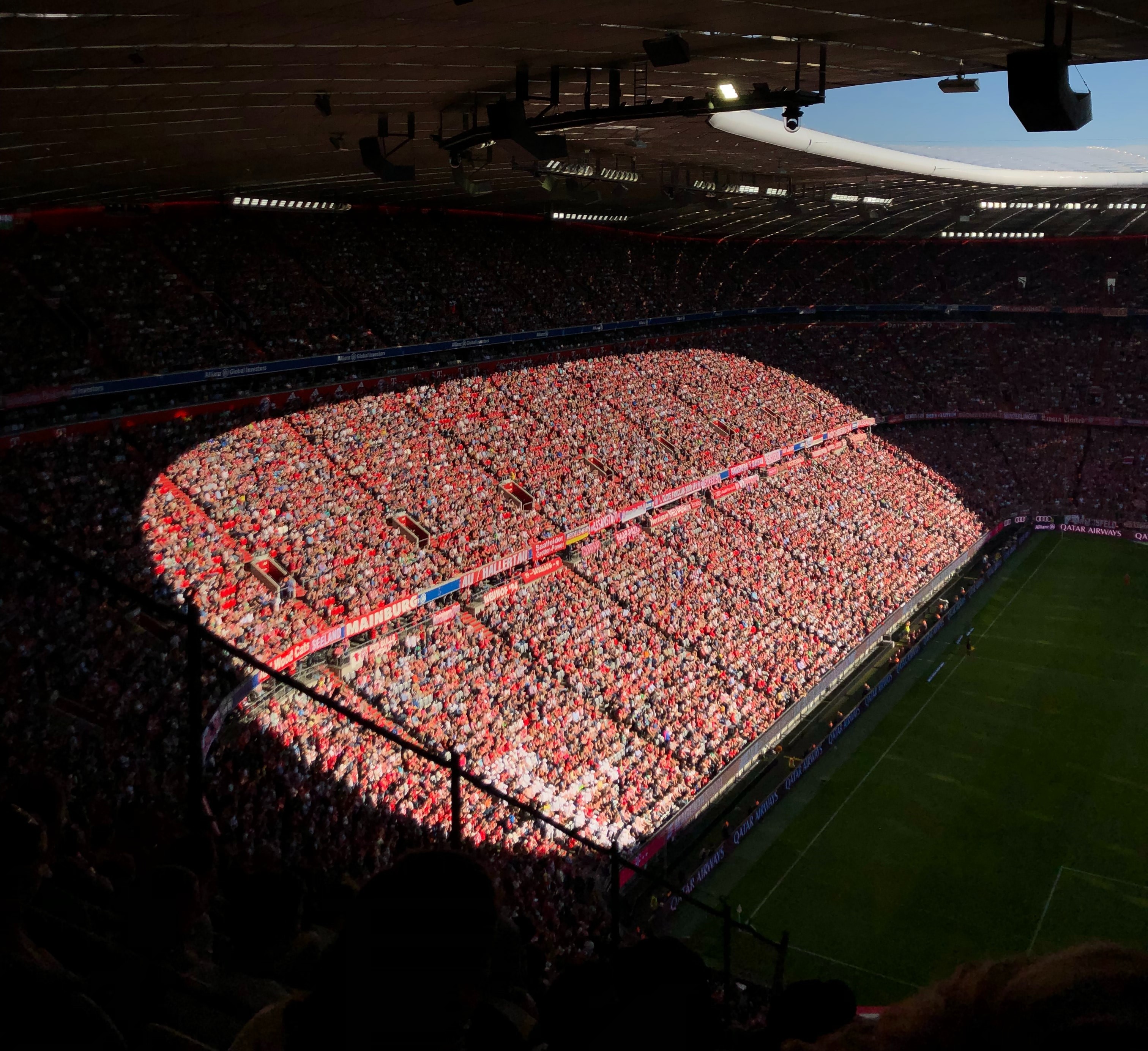View of fans at sports stadium where sun is directly pointing at some fans causing poor thermal comfort