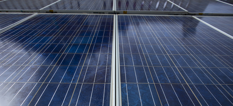 Solar panel with shadow of building cast onto it