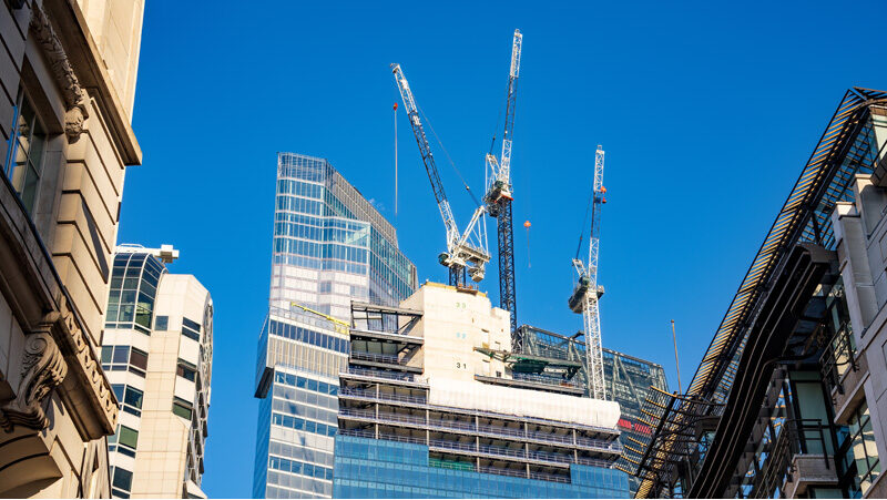 construction cranes on top of building