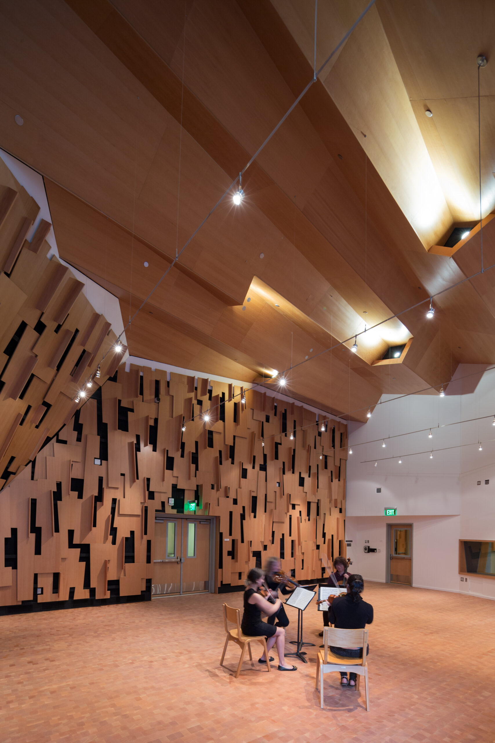Four people playing instruments inside UCLA’s $10 million state-of-the-art campus music facility, the Evelyn & Mo Ostin Music Center, in Los Angeles