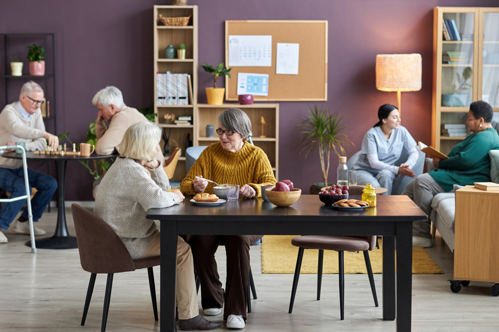 Seniors sitting in a social room in a retirement home.