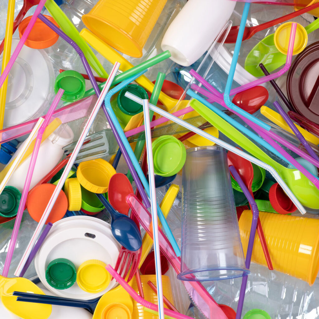 Image of single use plastics including cups, straws and cutlery